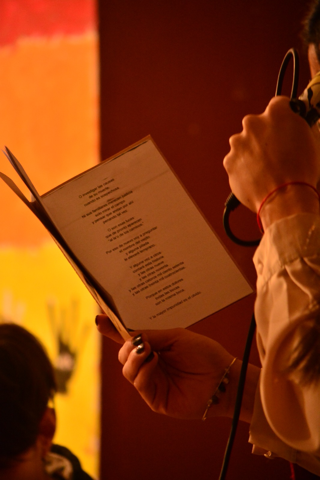 The hand of María Lew holds a book.