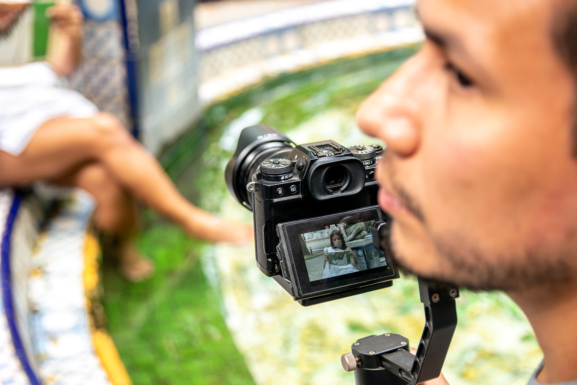 Photograph of a man behind a camera.