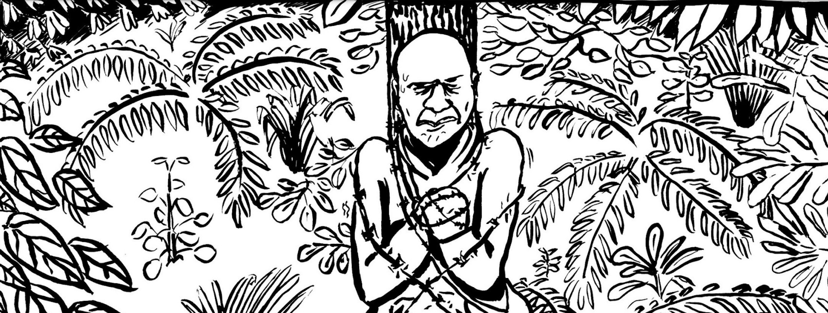 View of a man tied to a stake with barbed wire, with thick foliage behind.