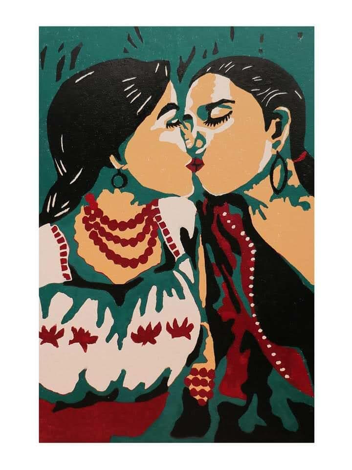 Two women in vibrant folkloric dress lean close together, adorned with bold jewellery and patterned clothing.