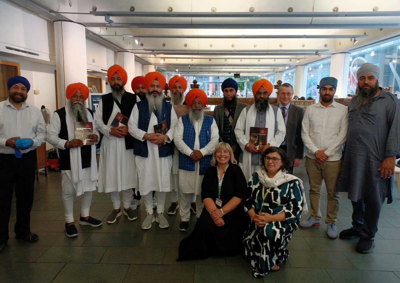 Group photograph featuring all those involved with the Sri Darbar visit, twelve are standing and two are kneeling.