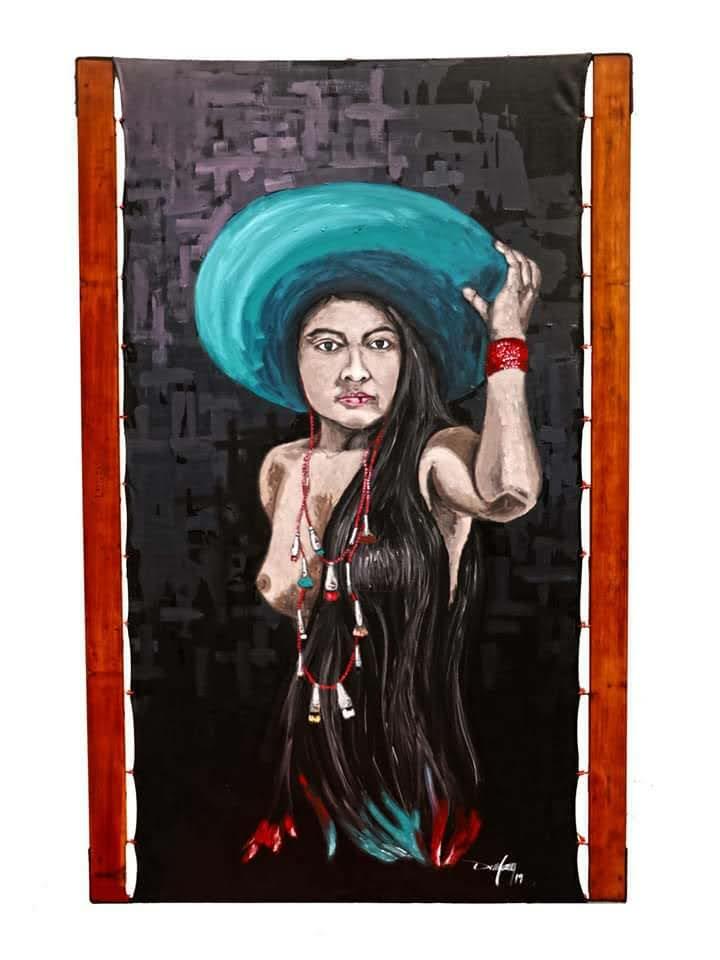 A figure lifts a large turquoise hat, long dark hair flowing, adorned with colourful beads and wooden framing.